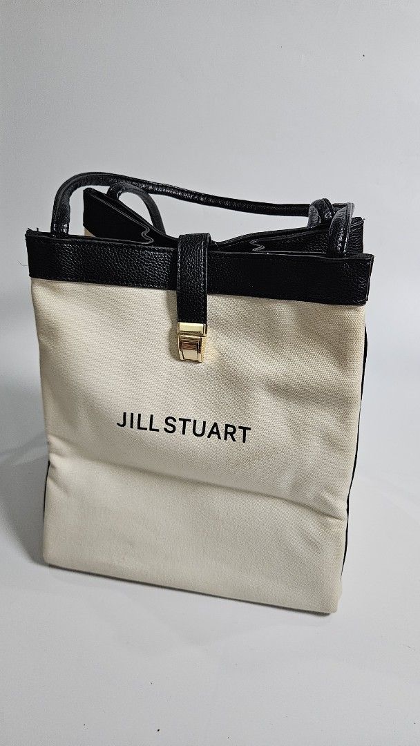 Jill Stuart Canvas Tote Bag (Category: Tote Bags) located in Alfonso. Submitted by jbcamet (Listing ID 1461711780, Image 2). Description: - Brand: Jill Stuart - Color: Cream canvas with black leather trim - Closure: Gold buckle - Interior: Features Jill Stuart tag - Features: Spacious, ideal for everyday use or travel.
