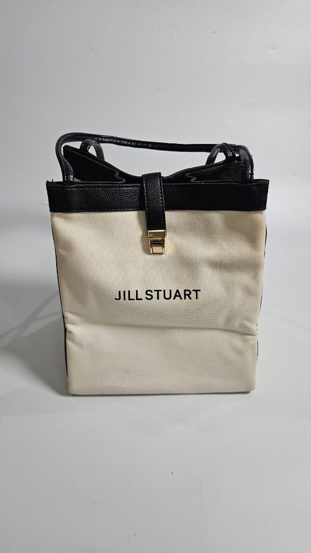 Jill Stuart Canvas Tote Bag (Category: Tote Bags) located in Alfonso. Submitted by jbcamet (Listing ID 1461711780, Image 1). Description: - Brand: Jill Stuart - Color: Cream canvas with black leather trim - Closure: Gold buckle - Interior: Features Jill Stuart tag - Features: Spacious, ideal for everyday use or travel.