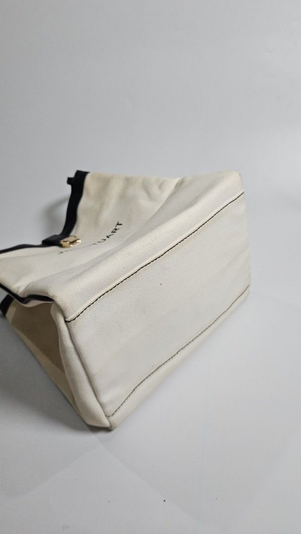 Jill Stuart Canvas Tote Bag (Category: Tote Bags) located in Alfonso. Submitted by jbcamet (Listing ID 1461711780, Image 3). Description: - Brand: Jill Stuart - Color: Cream canvas with black leather trim - Closure: Gold buckle - Interior: Features Jill Stuart tag - Features: Spacious, ideal for everyday use or travel.