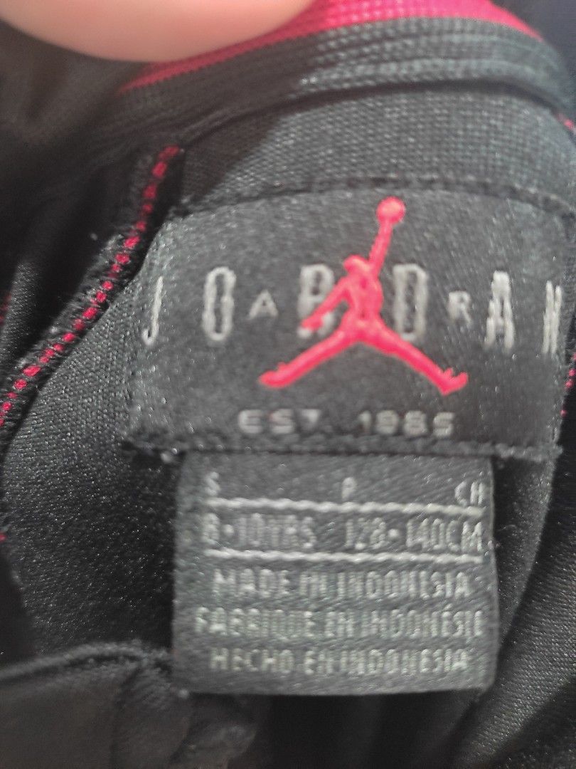 Jordan Air Track Jacket Black Red (Category: Babies & Kids Fashion) located in Pasay City. Submitted by mirabrie (Listing ID 1461568482, Image 2). Description: - Classic black Jordan track jacket - Bold red piping detail - Iconic Jumpman logo and 'AIR' text - Full zip closure for easy wear - Ribbed cuffs and hem for a snug fit - Ideal for both casual outings and athletic activities.