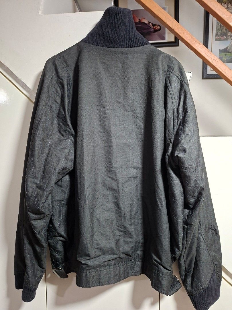 Jordan Bomber Jacket Black Size L (Category: Coats, Jackets and Outerwear) located in Cebu City. Submitted by anton_delos_reyes (Listing ID 1461624820, Image 2). Description: - Black Jordan bomber jacket - Size: Large (L) - Origin: Made in Thailand - Closure: Zip-up front - Pockets: Multiple zip pockets - Details: Ribbed collar, cuffs, and hem - Design: Subtle fabric pattern - Branding: Embroidered Jumpman logo on chest.