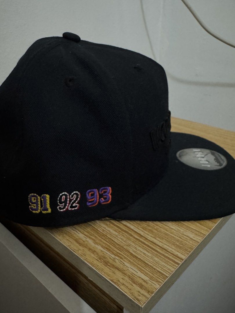 Jordan World Champions Again and Again Snapback Cap (Category: Caps & Hats) located in Bulacan. Submitted by alshopie (Listing ID 1461635715, Image 2). Description: - Black Jordan snapback cap - Embroidered 'WORLD CHAMPS AGAIN AND AGAIN' on the front - Embroidered '91 92 93' on the side - Original Jordan logo sticker still on the brim - Ideal for any Michael Jordan enthusiast.