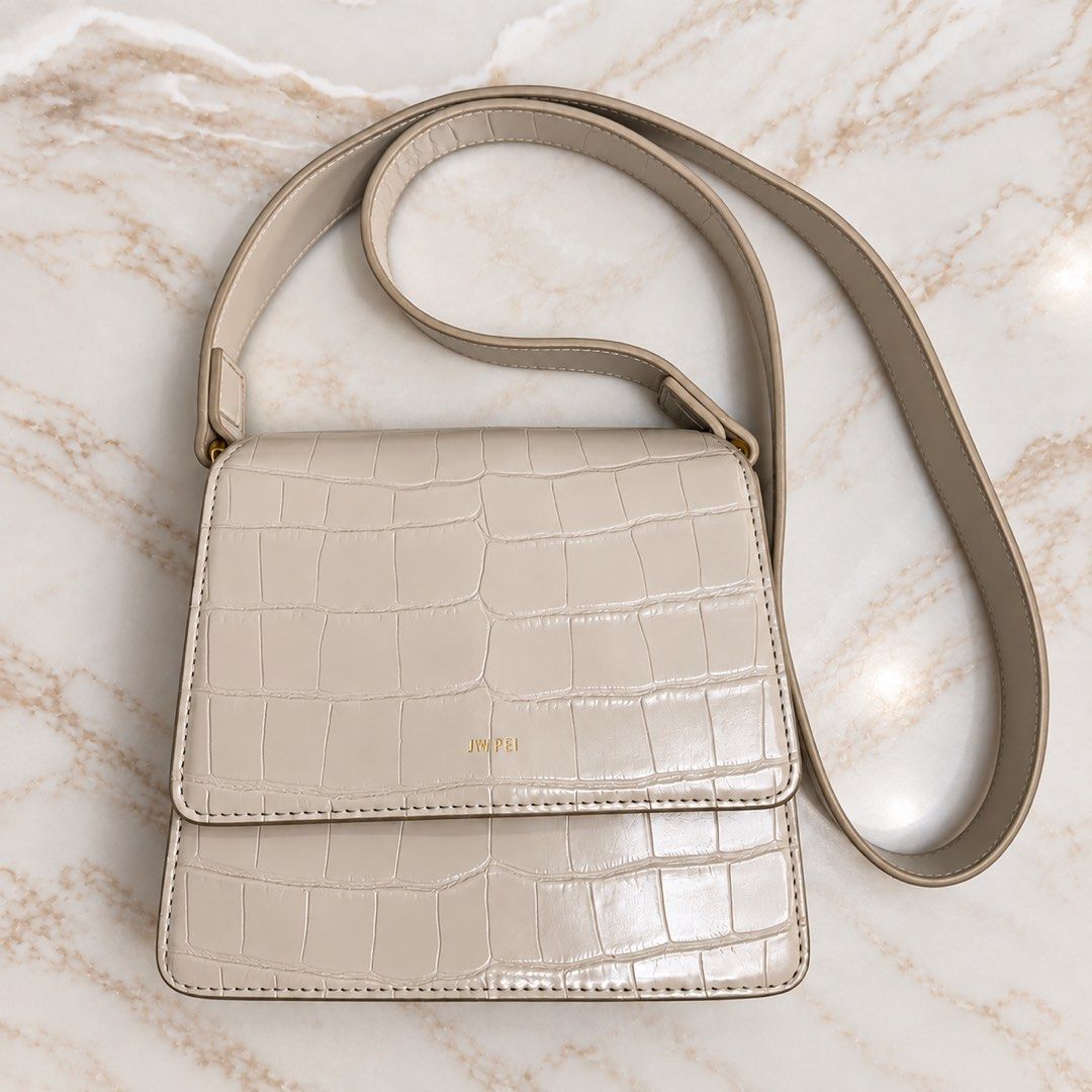 JW Pei Cream Croc Embossed Shoulder Bag (Category: Shoulder Bags) located in Makati City. Submitted by stylehub.mnl (Listing ID 1461569157, Image 1). Description: - Cream colored shoulder bag - Croc embossed texture - Gold hardware details - Adjustable strap - Magnetic closure - Spacious interior for essentials - Versatile for day or night use.