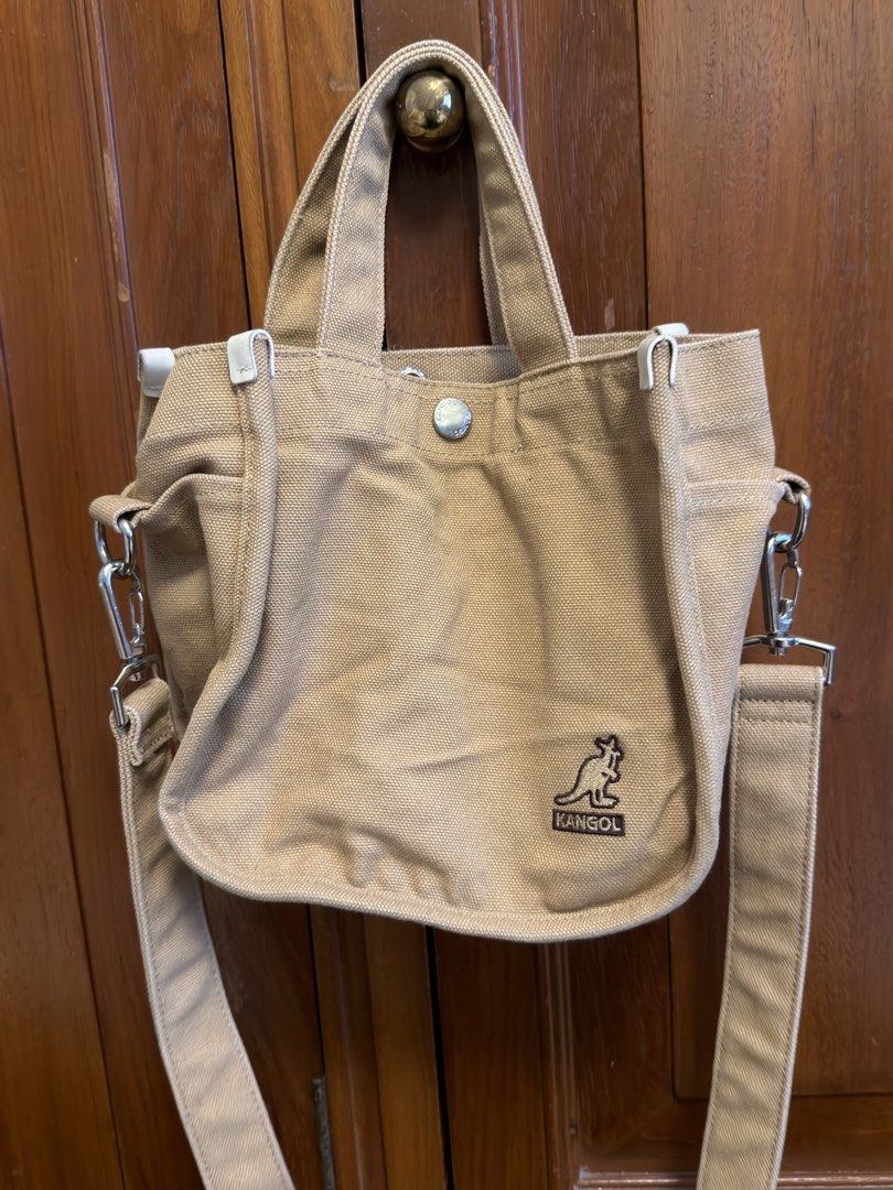 Kangol Canvas Small Tote Bag with Sling (Category: Tote Bags) located in Tarlac. Submitted by jzennoroyy-32960 (Listing ID 1461605614, Image 1). Description: - Brand: Kangol - Color: Tan - Material: Canvas - Style: Tote Bag - Features: Top handles, detachable crossbody strap, compartment, interior zip pocket, small kangaroo logo on front - Ideal for: Everyday use.