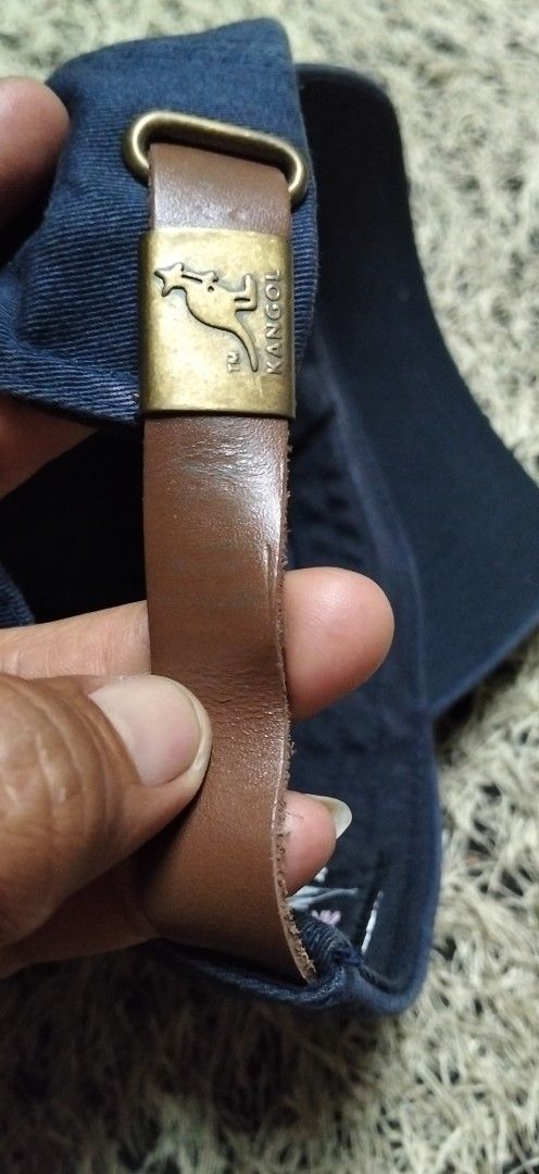 Kangol Navy Blue Cap with Leather Strap authentic (Category: Caps & Hats) located in Paranaque City. Submitted by michael-08 (Listing ID 1461591147, Image 3). Description: - Classic navy blue Kangol cap - Iconic gold embroidered kangaroo logo on front - Adjustable leather strap with metal buckle at the back - Kangol logo embossed on the strap - Size: OS (One Size Fits Most) - Ideal for everyday casual wear KANGOL BORN BRITISH .WALA PO ISSUE GOOD 