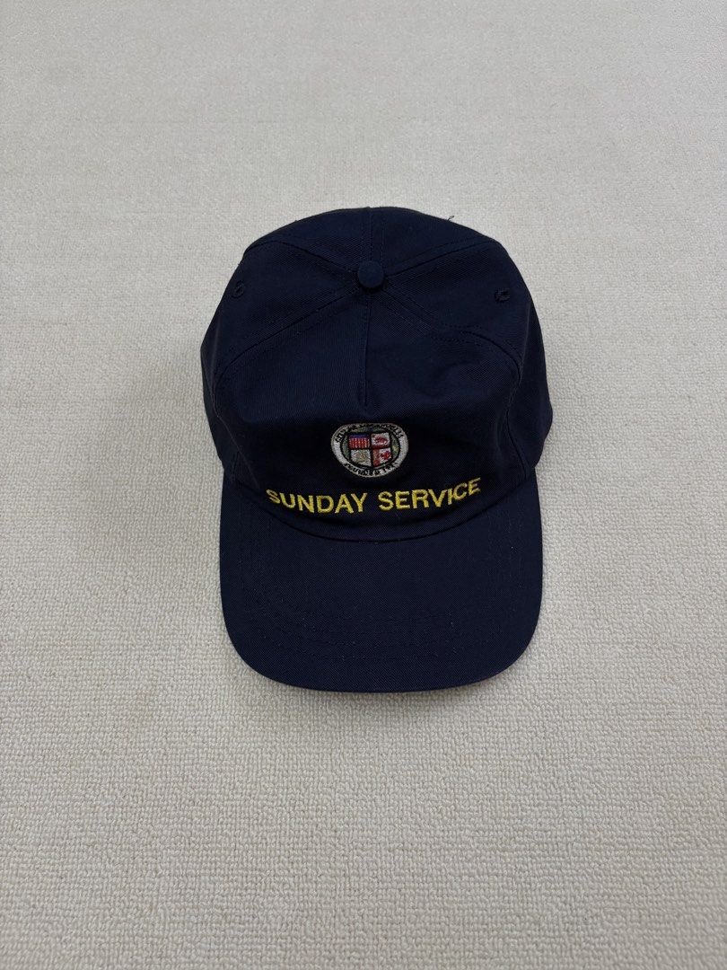 Kanye West sunday service hat (Category: Caps & Hats) located in Manila. Submitted by porma.market (Listing ID 1461577759, Image 2). Description: - Navy blue baseball cap - Features 'SUNDAY SERVICE' embroidered in yellow on the front - Includes a circular logo above the text - 'MADE IN USA' tag inside - Simple and classic design.