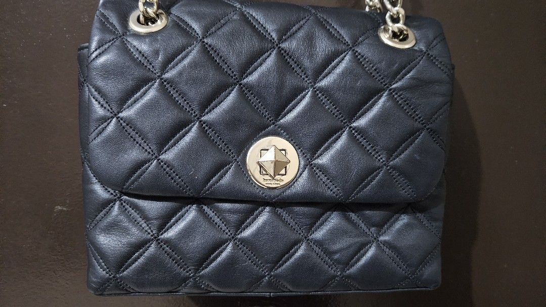 Kate Spade Black Quilted Leather Chain Shoulder Bag (Category: Luxury Bags & Wallets) located in Quezon City. Submitted by gabrielscloset (Listing ID 1461652940, Image 2). Description: - Brand: Kate Spade - Material: Black quilted leather - Hardware: Silver turn-lock closure and chain strap with leather accents - Interior: Black lining with spade pattern - Style: Shoulder bag - Versatile: Ideal for day or night use.