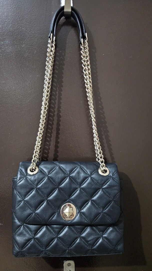 Kate Spade Black Quilted Leather Chain Shoulder Bag (Category: Luxury Bags & Wallets) located in Quezon City. Submitted by gabrielscloset (Listing ID 1461652940, Image 1). Description: - Brand: Kate Spade - Material: Black quilted leather - Hardware: Silver turn-lock closure and chain strap with leather accents - Interior: Black lining with spade pattern - Style: Shoulder bag - Versatile: Ideal for day or night use.