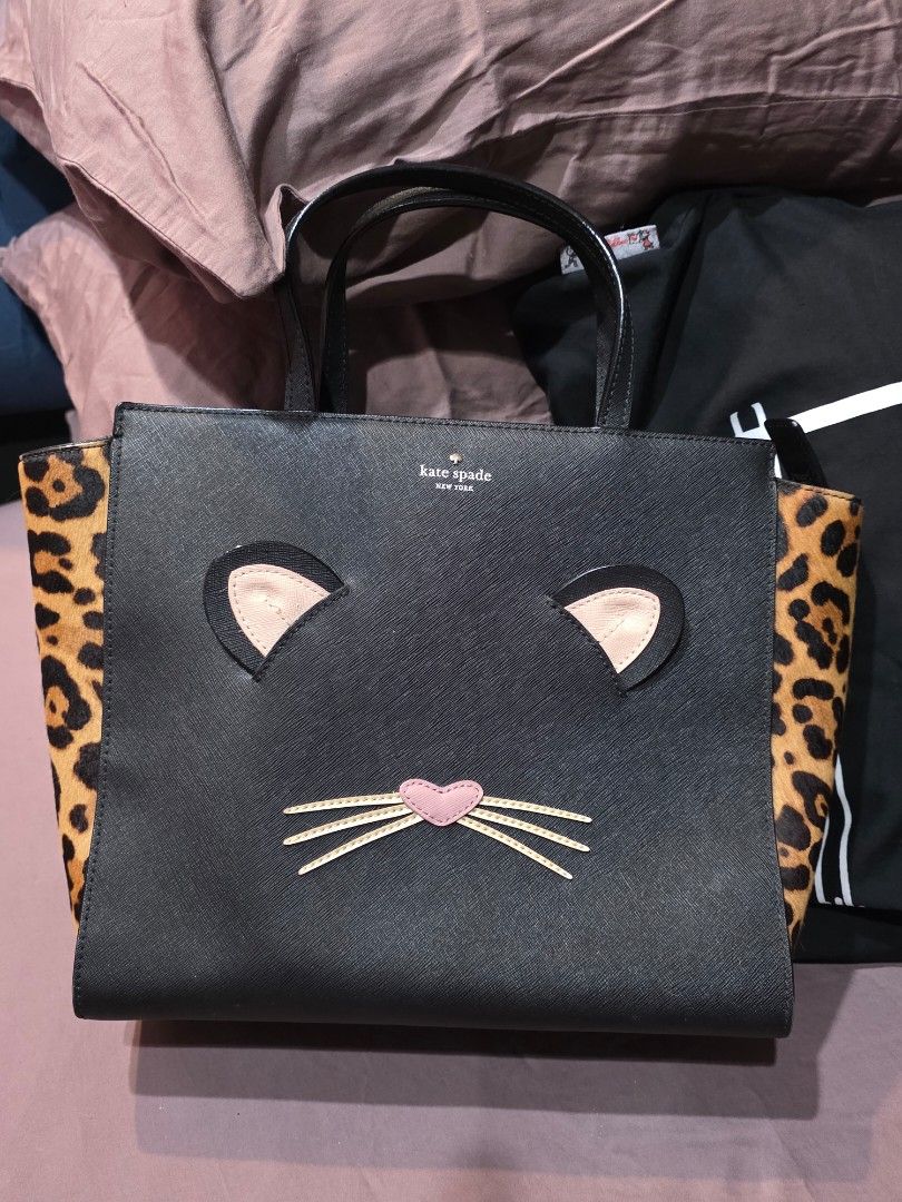 Kate Spade Hayden Set (Category: Luxury Bags & Wallets) located in Taguig. Submitted by lovedbymicah (Listing ID 1461645024, Image 2). Description: - Brand: Kate Spade - Model: Hayden Set (Mama & Baby) - Color: Black with leopard print accents - Design: Cute cat face with ears and whiskers - Material: Saffiano leather - Includes: Two bags (larger Mama Hayden and smaller Baby Hayden both w long strap) - Unique Feature: Playful and charming cat-the