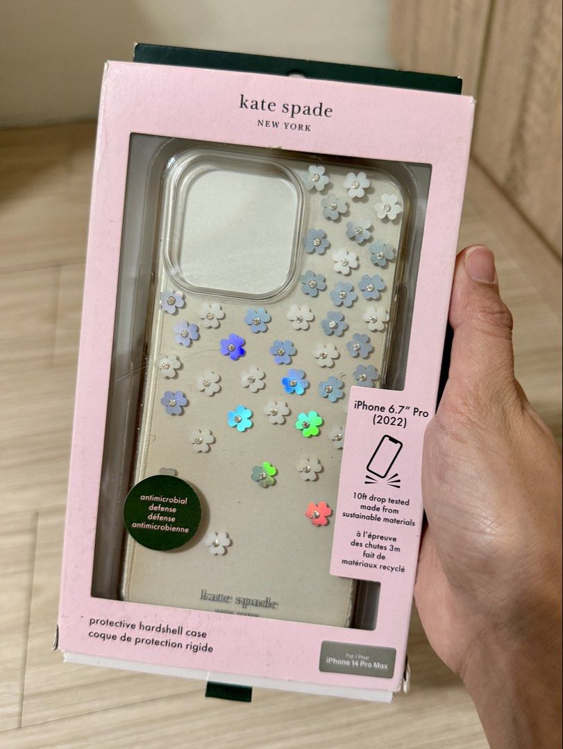 Kate Spade iPhone 14 Pro Max Case (Category: Cases & Sleeves) located in Manila. Submitted by carad__ (Listing ID 1461725293, Image 1). Description: - Brand: Kate Spade - Model: iPhone 14 Pro Max - Design: Clear hardshell case with charming floral embellishments - Features: Antimicrobial defense, 10ft drop tested - Material: Made from sustainable materials - Protection: Protective hardshell for everyday use.