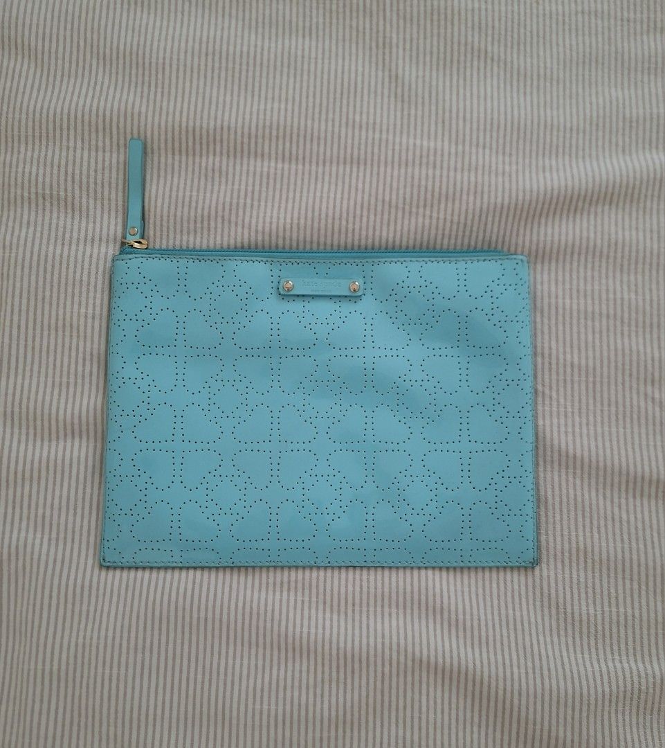 Kate Spade Turquoise Perforated Pouch Clutch (Category: Purses & Pouches) located in Pasig City. Submitted by avcan (Listing ID 1461580107, Image 1). Description: - Authentic Kate Spade pouch in a vibrant turquoise color. - Features a chic all-over perforated pattern. - Secure and fully functional zipper closure. - Interior slip pockets for organization. - Ideal for storing essentials..
