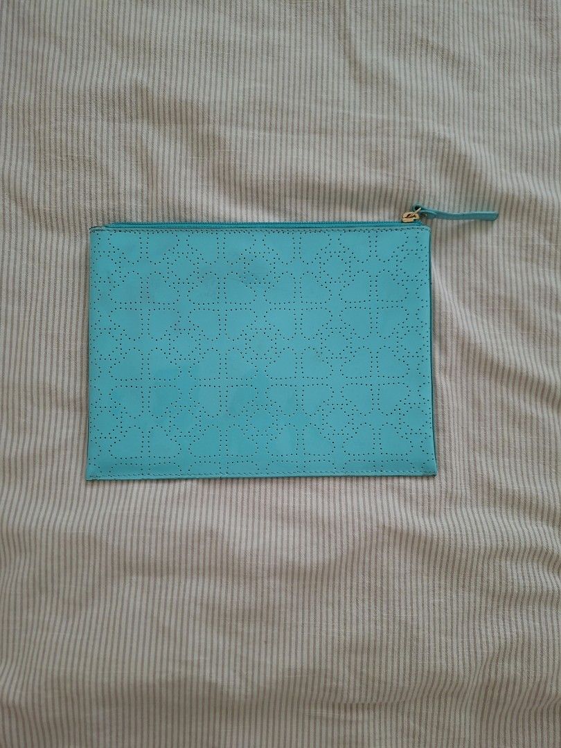 Kate Spade Turquoise Perforated Pouch Clutch (Category: Purses & Pouches) located in Pasig City. Submitted by avcan (Listing ID 1461580107, Image 2). Description: - Authentic Kate Spade pouch in a vibrant turquoise color. - Features a chic all-over perforated pattern. - Secure and fully functional zipper closure. - Interior slip pockets for organization. - Ideal for storing essentials..