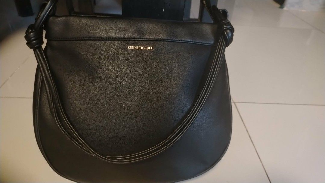 Kenneth Cole Black Leather Shoulder Bag (Category: Shoulder Bags) located in Manila. Submitted by wildwind_73f77a (Listing ID 1461586389, Image 1). Description: - Kenneth Cole New York black leather shoulder bag - Main zip compartment - Exterior zip pocket - Knot detail on strap ends - Gold-tone hardware - Clean interior.
