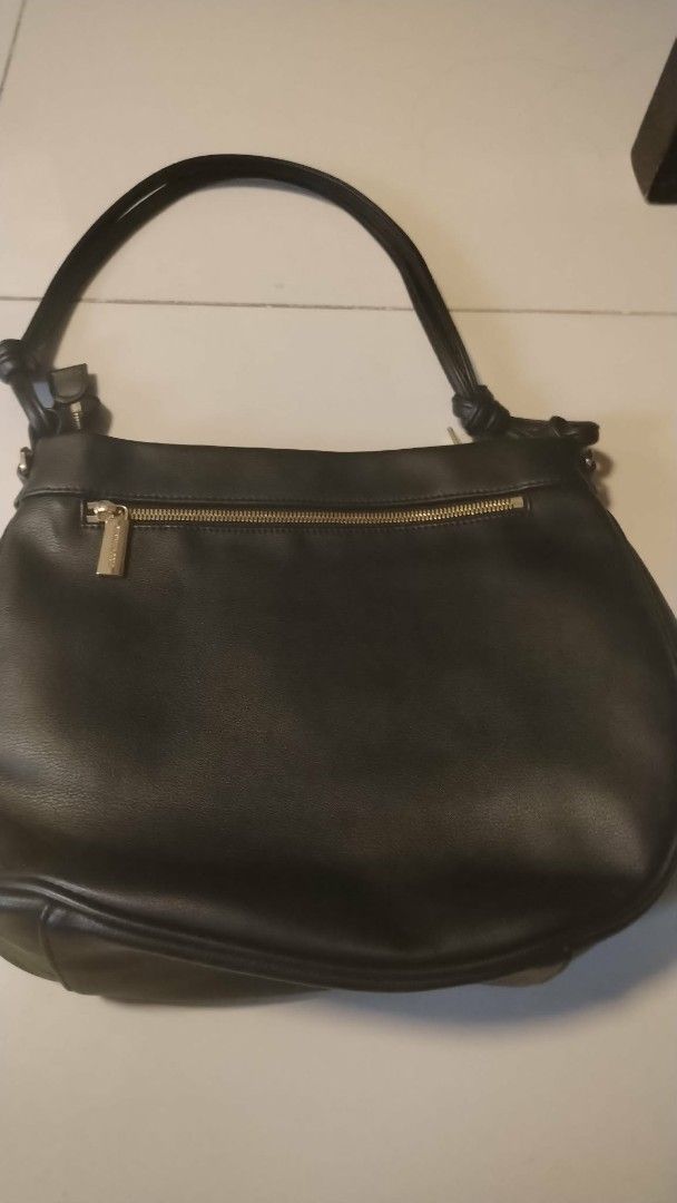 Kenneth Cole Black Leather Shoulder Bag (Category: Shoulder Bags) located in Manila. Submitted by wildwind_73f77a (Listing ID 1461586389, Image 3). Description: - Kenneth Cole New York black leather shoulder bag - Main zip compartment - Exterior zip pocket - Knot detail on strap ends - Gold-tone hardware - Clean interior.