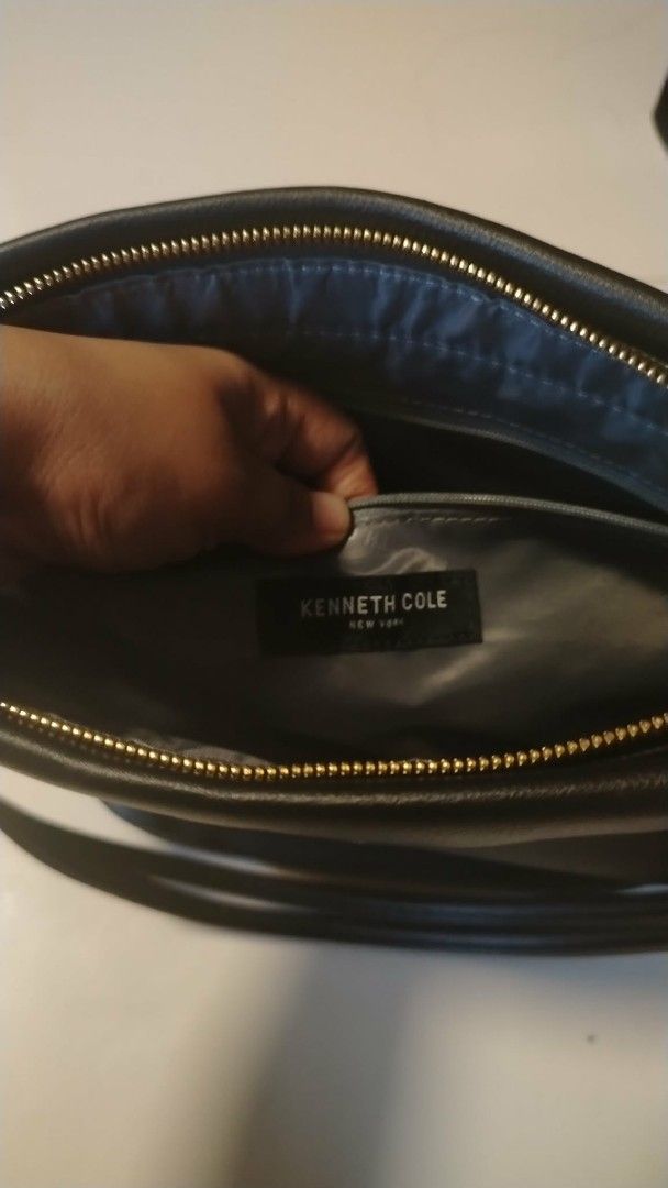 Kenneth Cole Black Leather Shoulder Bag (Category: Shoulder Bags) located in Manila. Submitted by wildwind_73f77a (Listing ID 1461586389, Image 2). Description: - Kenneth Cole New York black leather shoulder bag - Main zip compartment - Exterior zip pocket - Knot detail on strap ends - Gold-tone hardware - Clean interior.