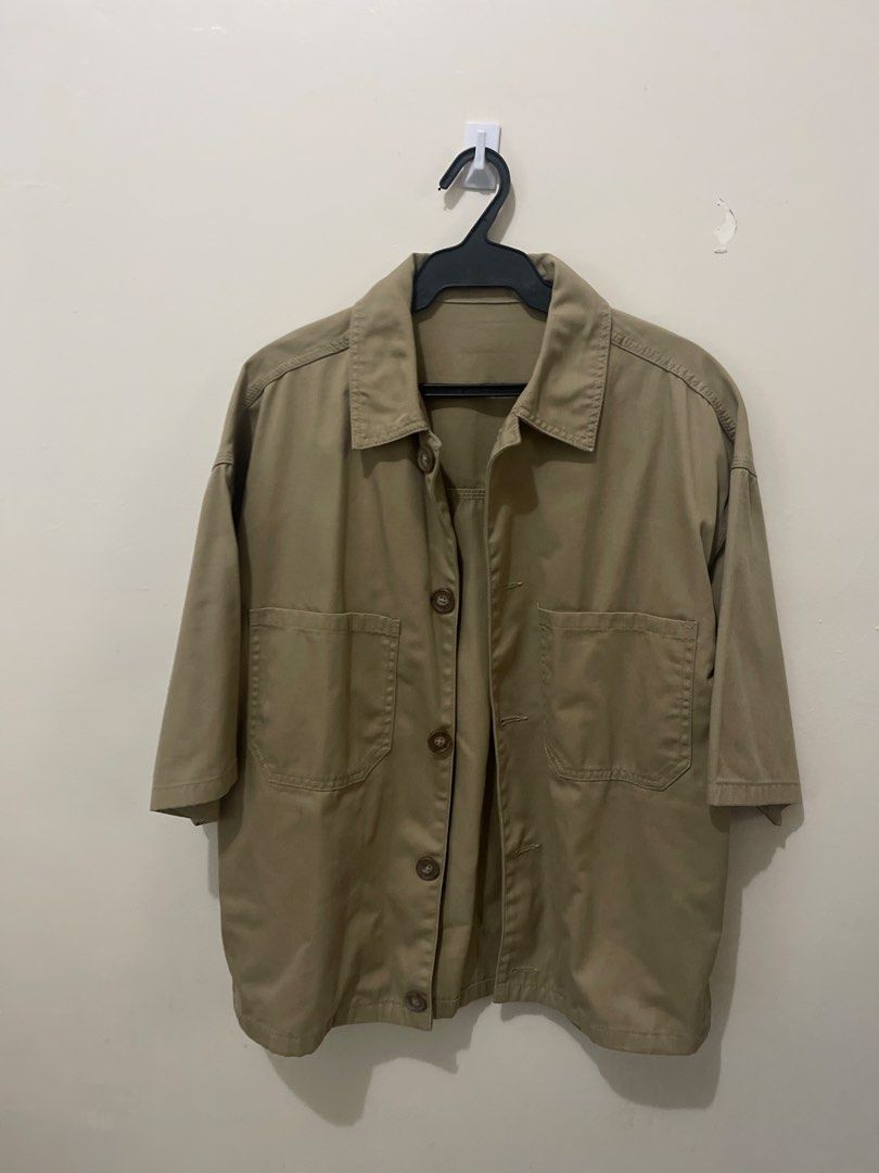 Khaki Short Sleeve Button-Up Shirt Jacket (Category: Tshirts & Polo Shirts ) located in Makati City. Submitted by renzzee (Listing ID 1461708984, Image 1). Description: - Khaki colored shirt jacket - Short sleeves - Two chest pockets with button closures - Button-up front - Ideal for casual layering - Versatile piece.