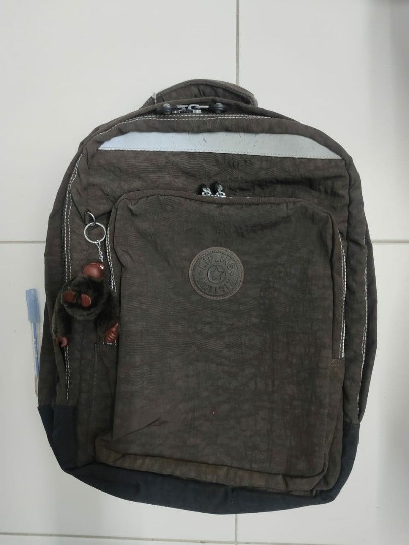 Kipling Backpack (Category: Backpacks) located in Merlimau. Submitted by daengmenabastore (Listing ID 1461746477, Image 1). Description: - Brand: Kipling - Color: Brown - Features iconic Kipling monkey charm - Durable material - Adjustable shoulder straps - Suitable for daily use, school, or travel Nego.