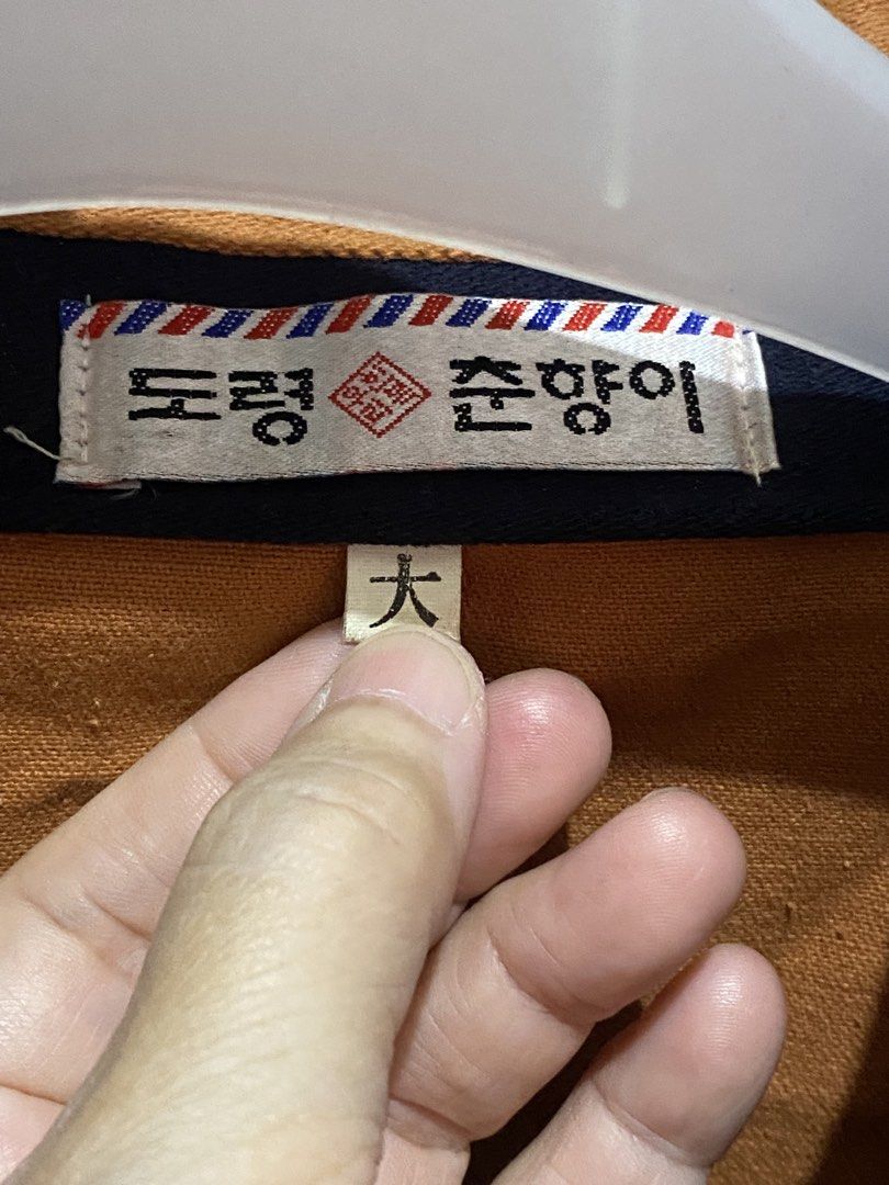Korean Traditional Style Jacket - Size Large (Category: Coats, Jackets and Outerwear) located in Manila. Submitted by resi.diaz (Listing ID 1461616713, Image 2). Description: - Unique brown jacket with navy blue trim - Features a distinctive knot closure and decorative buttons - Long sleeves with navy cuffs - Made in Korea - Tag: '도령춘향이' - Size: '大' (Large) - Approximate Measurements: Chest 23 inches, Length 30 inches.