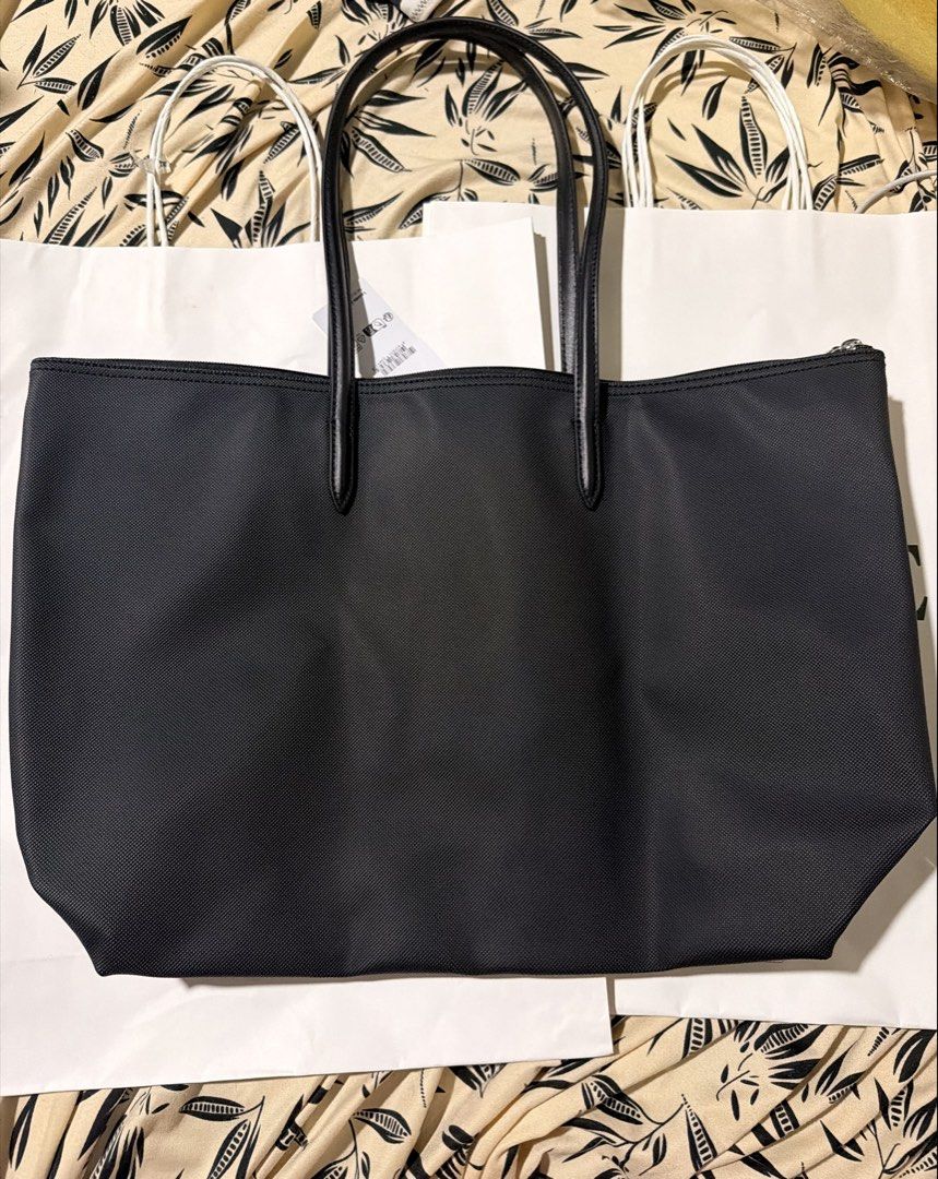 Lacoste Black Tote Bag with Tags (Category: Tote Bags) located in Quezon City. Submitted by pernella (Listing ID 1461726848, Image 3). Description: - Classic black Lacoste tote bag - Features the iconic crocodile logo - Made from durable material for everyday use - Plenty of interior space for essentials - Comfortable handles for easy carrying - Brand new with original tags attached + paperbag -Navy Blue is already sold.