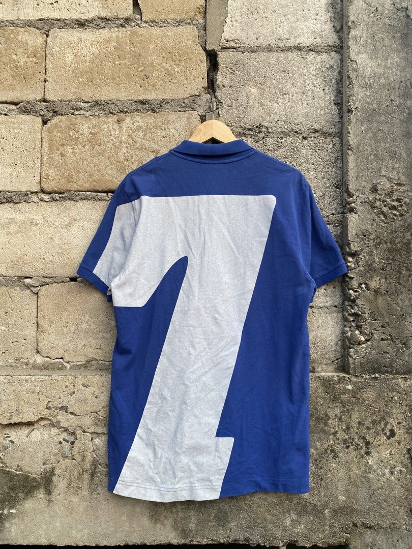 Lacoste Blue 27 Graphic Design (Category: Tshirts & Polo Shirts ) located in Candaba. Submitted by dejesus.bench17 (Listing ID 1461791357, Image 2). Description: Lacoste 27 Big Print Graphic Design -Color: Blue -Condition: Excellent -Color rate: 9/10 -Issue: Missing 1 button (see on pic) -Dimes: W20 L29 -Price: 1,499 + ship.