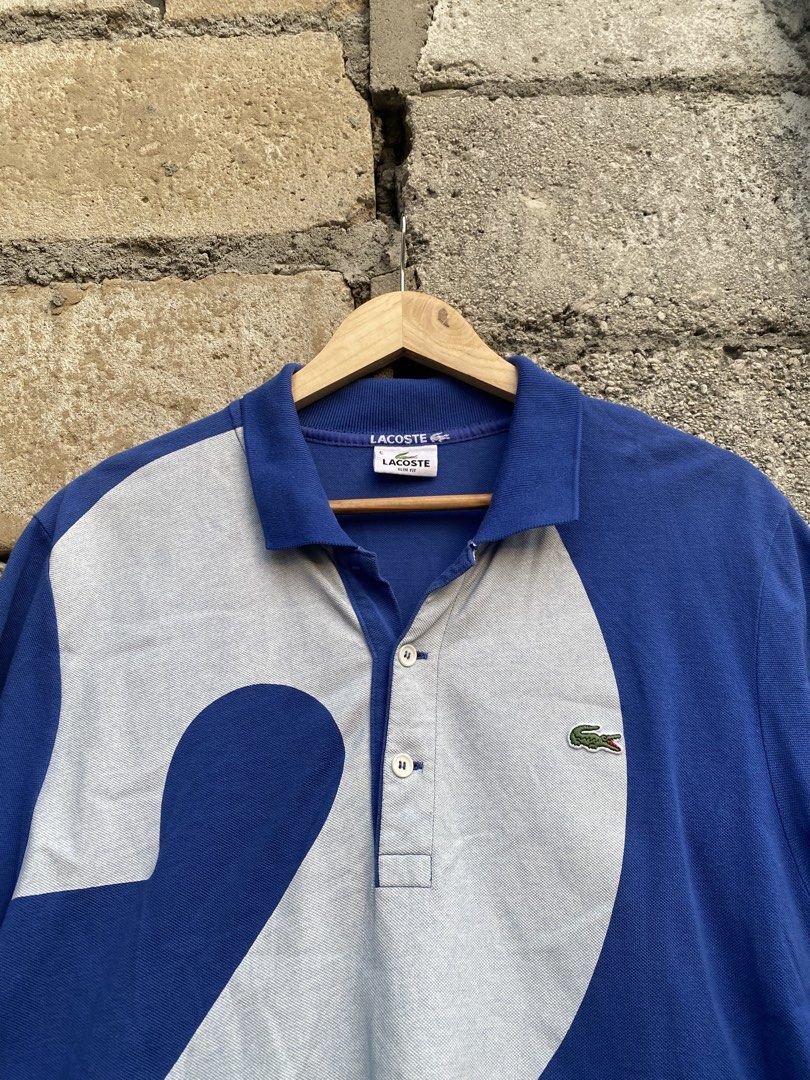 Lacoste Blue 27 Graphic Design (Category: Tshirts & Polo Shirts ) located in Candaba. Submitted by dejesus.bench17 (Listing ID 1461791357, Image 3). Description: Lacoste 27 Big Print Graphic Design -Color: Blue -Condition: Excellent -Color rate: 9/10 -Issue: Missing 1 button (see on pic) -Dimes: W20 L29 -Price: 1,499 + ship.