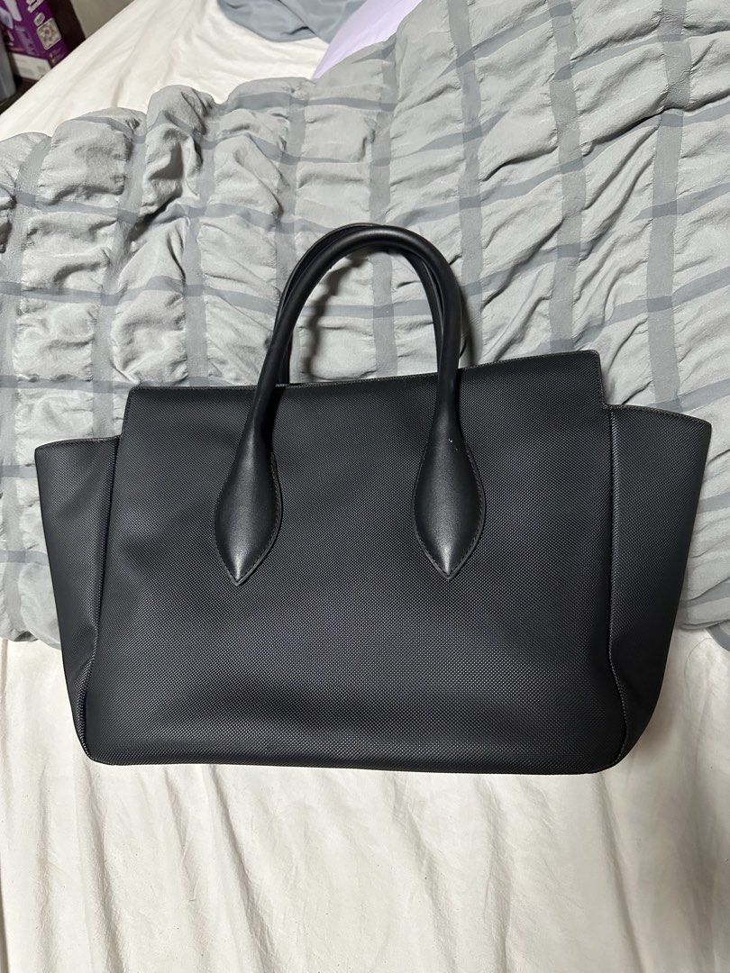Lacoste Daily City Tote Bag (Category: Tote Bags) located in Manila. Submitted by karlacotoc65578 (Listing ID 1461655717, Image 2). Description: - Authentic Black Lacoste Tote Bag - Textured Leather Exterior - Comfortable Top Handles - Secure Zipper Closure - Large Main Compartment - Ideal for Everyday Use or Travel - RFS: Declittering; not using it.