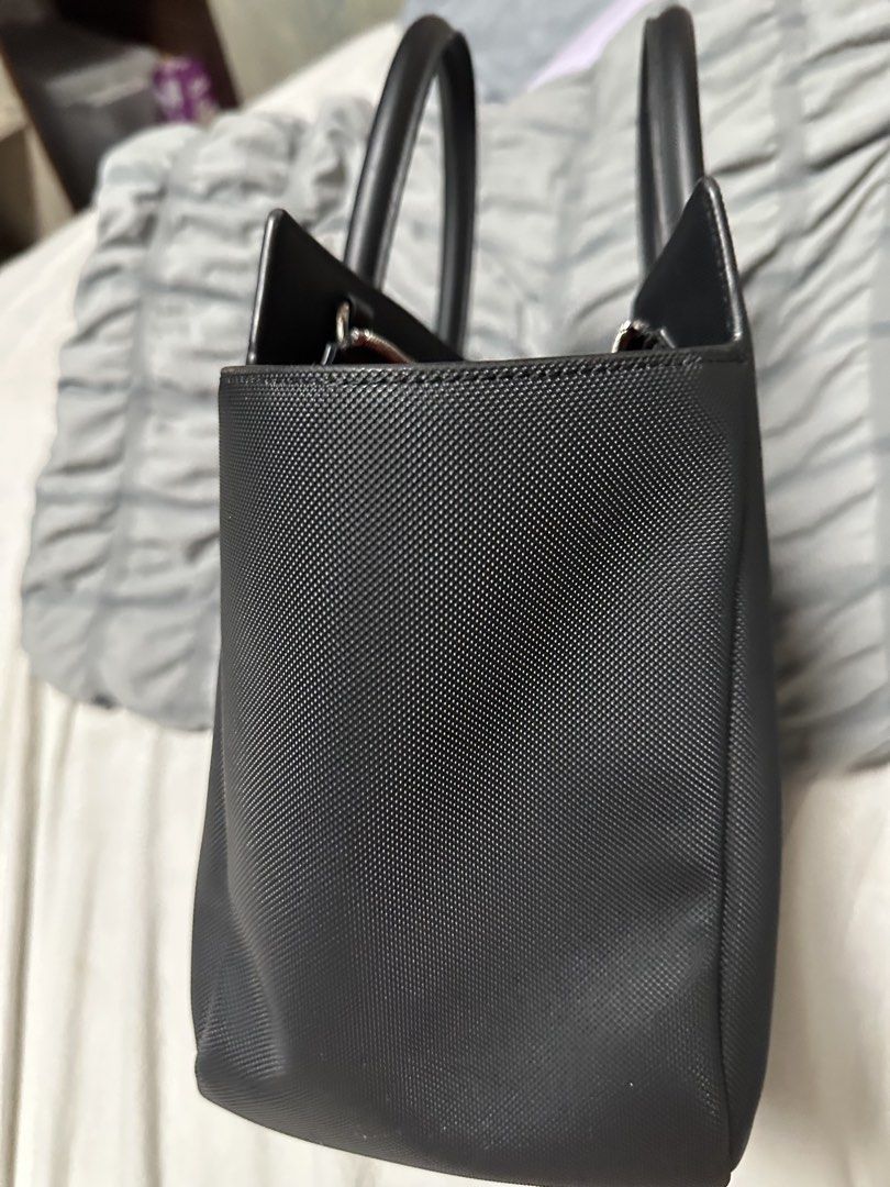 Lacoste Daily City Tote Bag (Category: Tote Bags) located in Manila. Submitted by karlacotoc65578 (Listing ID 1461655717, Image 3). Description: - Authentic Black Lacoste Tote Bag - Textured Leather Exterior - Comfortable Top Handles - Secure Zipper Closure - Large Main Compartment - Ideal for Everyday Use or Travel - RFS: Declittering; not using it.