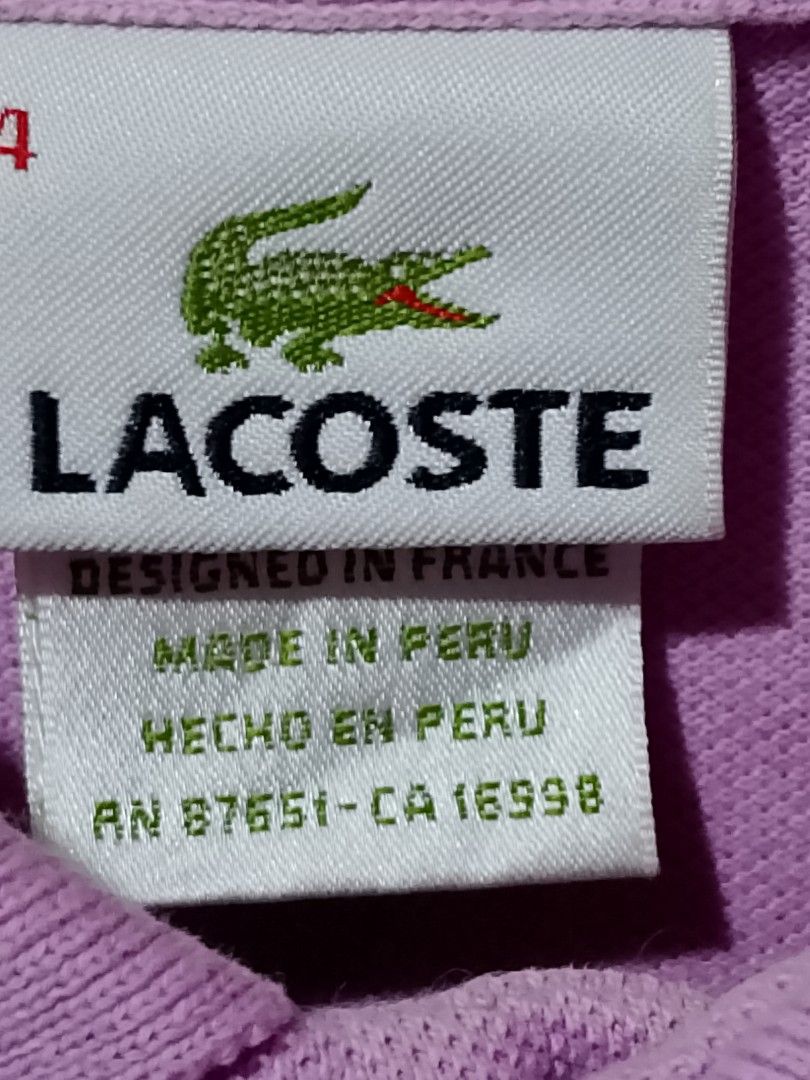 Lacoste Polo Shirt - Purple (Category: Tshirts & Polo Shirts ) located in San Pedro. Submitted by jokwanrocks09 (Listing ID 1461672771, Image 3). Description: Selling a classic Lacoste polo shirt. It's a lovely shade of purple. Features the iconic crocodile logo embroidered on the chest. Made in Peru, designed in France. Great for casual wear or a smart-casual look. Check the photos for details. 19x26 medium .