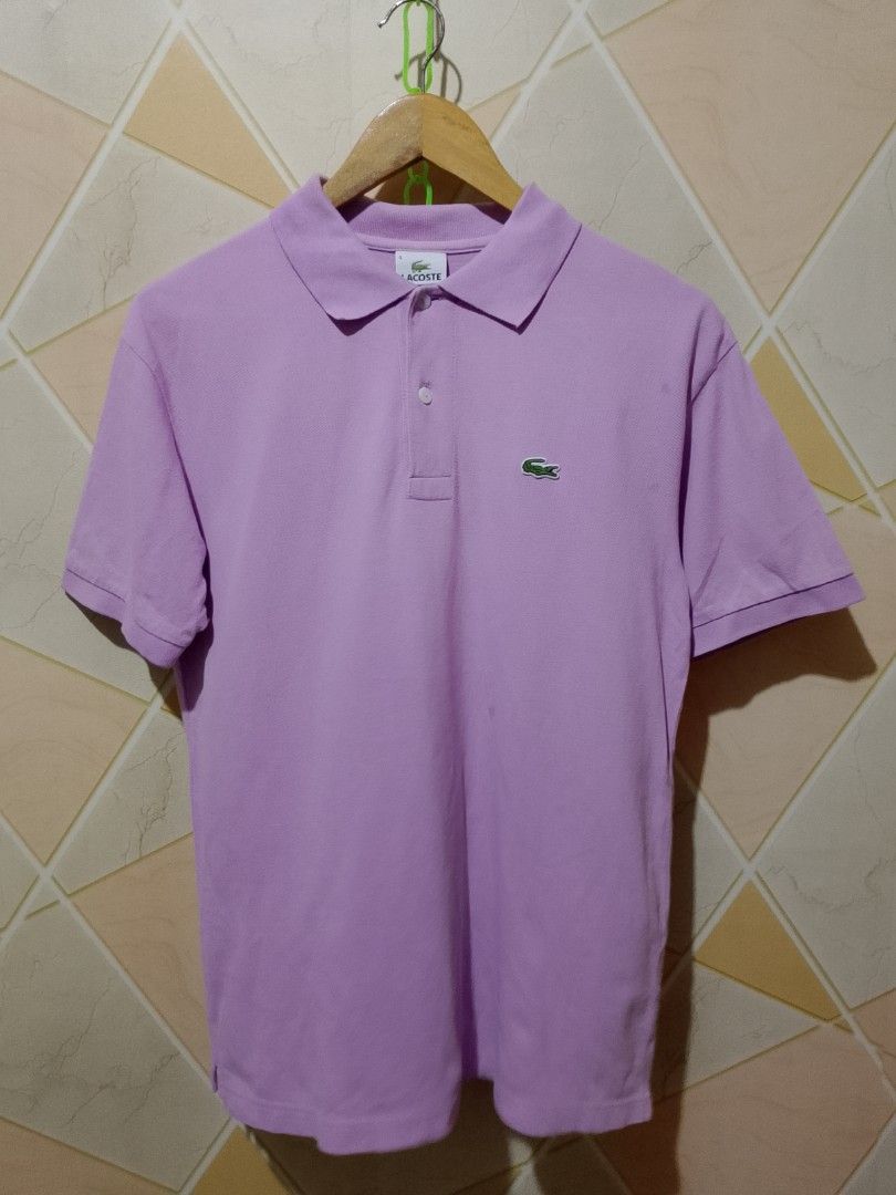Lacoste Polo Shirt - Purple (Category: Tshirts & Polo Shirts ) located in San Pedro. Submitted by jokwanrocks09 (Listing ID 1461672771, Image 1). Description: Selling a classic Lacoste polo shirt. It's a lovely shade of purple. Features the iconic crocodile logo embroidered on the chest. Made in Peru, designed in France. Great for casual wear or a smart-casual look. Check the photos for details. 19x26 medium .