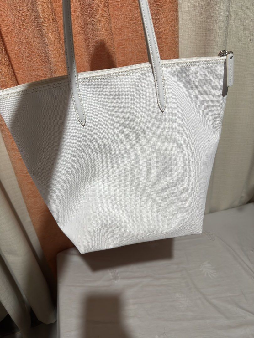 Lacoste White Tote Bag (Category: Tote Bags) located in San Mateo. Submitted by rkg_agbayani (Listing ID 1461596747, Image 3). Description: - Classic white Lacoste tote bag - Features the iconic crocodile logo - Secure zipper closure - Spacious interior for essentials - Comfortable shoulder straps - Ideal for everyday use or travel.