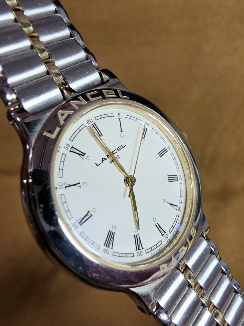 Lancel Paris Two-Tone Watch Original (Category: Women's Watches) located in Rosales. Submitted by akumie30 (Listing ID 1461688846, Image 3). Description: - Brand: Lancel Paris - Bracelet: Two-tone metal with gold accents - Dial: White with Roman numerals - Features: Water resistant, Made in Japan - Condition: Good, with some signs of wear on bracelet and clasp. Timepiece is functional. All Original Watch only hindi po kasama ang Box Case Size 32.