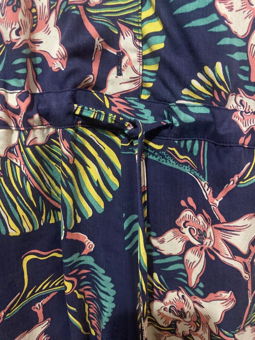 Levi's Navy Floral Sleeveless Romper (Category: Dresses) located in Manila. Submitted by angelaay143 (Listing ID 1461775462, Image 2). Description: - Brand: Levi's - Style: Romper - Print: Vibrant floral (navy blue base with pink, yellow, green flowers/leaves) - Design: Sleeveless, collared neckline - Features: Tie waist for cinched look, two front pockets - Occasion: Casual day out, vacation vibe - worn once - Needs laundry atored too long at th