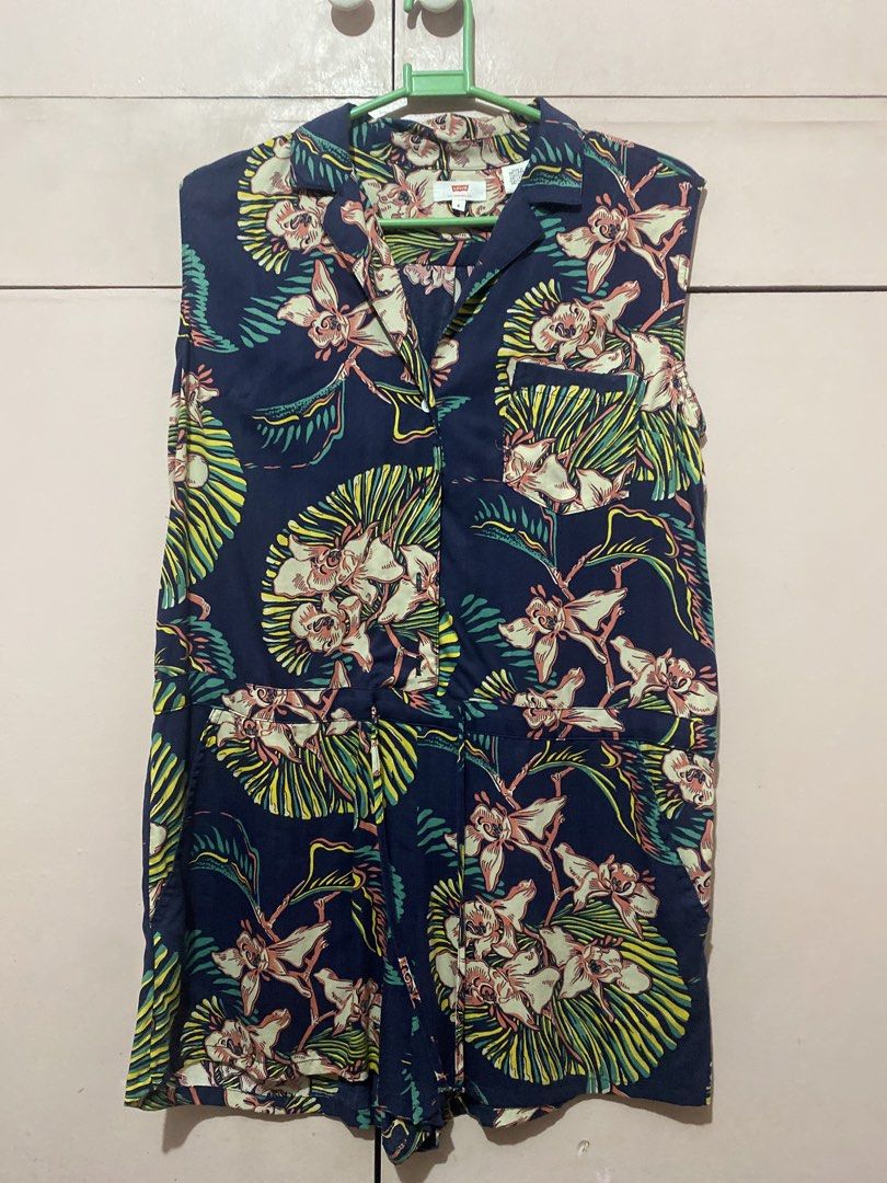 Levi's Navy Floral Sleeveless Romper (Category: Dresses) located in Manila. Submitted by angelaay143 (Listing ID 1461775462, Image 1). Description: - Brand: Levi's - Style: Romper - Print: Vibrant floral (navy blue base with pink, yellow, green flowers/leaves) - Design: Sleeveless, collared neckline - Features: Tie waist for cinched look, two front pockets - Occasion: Casual day out, vacation vibe - worn once - Needs laundry atored too long at th