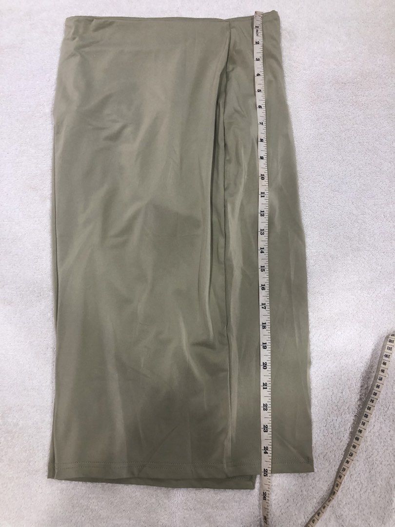 Light Beige Wrap Midi Skirt (Category: Skirts) located in Manila. Submitted by janmichael26601 (Listing ID 1461620826, Image 2). Description: - Light beige midi skirt - Wrap style with a slit - Approximately 24 inches in length - Fabric has a subtle sheen - Best fits a size medium - Perfect for dressing up or down.