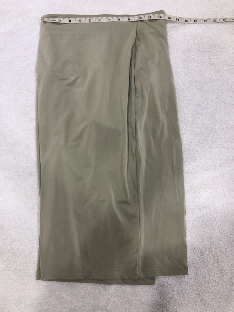 Light Beige Wrap Midi Skirt (Category: Skirts) located in Manila. Submitted by janmichael26601 (Listing ID 1461620826, Image 1). Description: - Light beige midi skirt - Wrap style with a slit - Approximately 24 inches in length - Fabric has a subtle sheen - Best fits a size medium - Perfect for dressing up or down.
