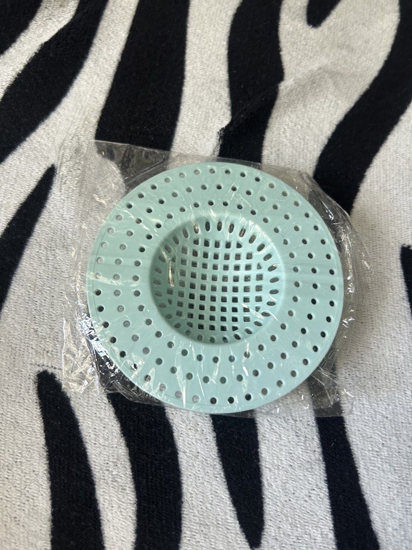 Light blue plastic sink strainer with grid pattern and holes for filtering debris (Category: Bathroom & Kitchen Fixtures) located in General Trias. Submitted by aprilocampo0412 (Listing ID 1461621435, Image 1). Description: Light blue plastic sink strainer with grid pattern and holes for filtering debris.