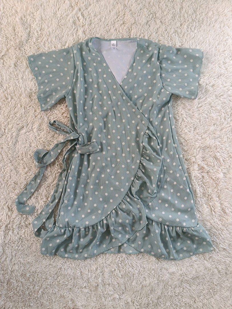 Light Blue Polka Dot Wrap Dress with Ruffles (Category: Dresses) located in Bocaue. Submitted by tacobellaaa (Listing ID 1461644654, Image 1). Description: - Light blue wrap dress - White polka dot pattern - Flutter sleeves - Ruffled hem - Adjustable side tie - Ideal for casual outings or beach days.