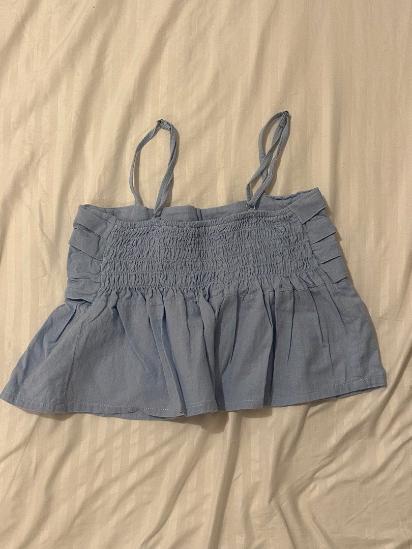Light Blue Smocked Ruffle Cami Top (Category: Sleeveless) located in Santo Tomas. Submitted by prelovedspacesbyji (Listing ID 1461760070, Image 2). Description: - Cute light blue cami top - Smocked bodice with bust ruffles - Ruffled, flared hem - Adjustable spaghetti straps - Easy to pair with shorts or skirts for a casual look.