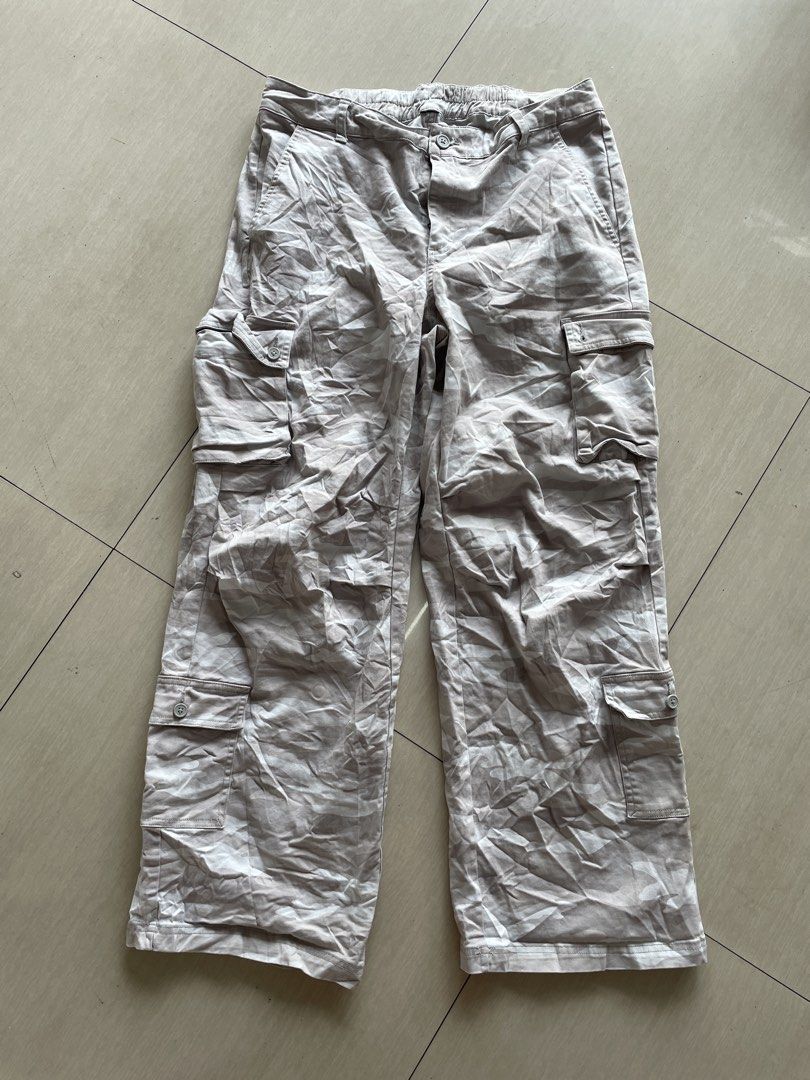 Light Grey Cargo Pants with Pockets (Category: Jeans) located in Lucena. Submitted by riyizthriftz (Listing ID 1461562523, Image 1). Description: - Light grey cargo pants - Multiple pockets for ample storage - Front button and zip closure - Elastic waistband at the back for a comfortable, adjustable fit - Made with 98% cotton and 2% spandex for durability and a slight stretch - Ideal for casual outings and everyday wear.