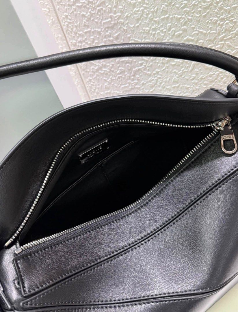 LOEWE (Category: Luxury Bags & Wallets) located in Bacoor. Submitted by ricric0918 (Listing ID 1461629876, Image 3). Description: Brand: LOEWE Model: Puzzle Bag (Shoulder / Hobo style layout) Color: Black with silver-tone hardware Material: Smooth calfskin leather (Interior features metal “LOEWE Made in Spain” plaque).