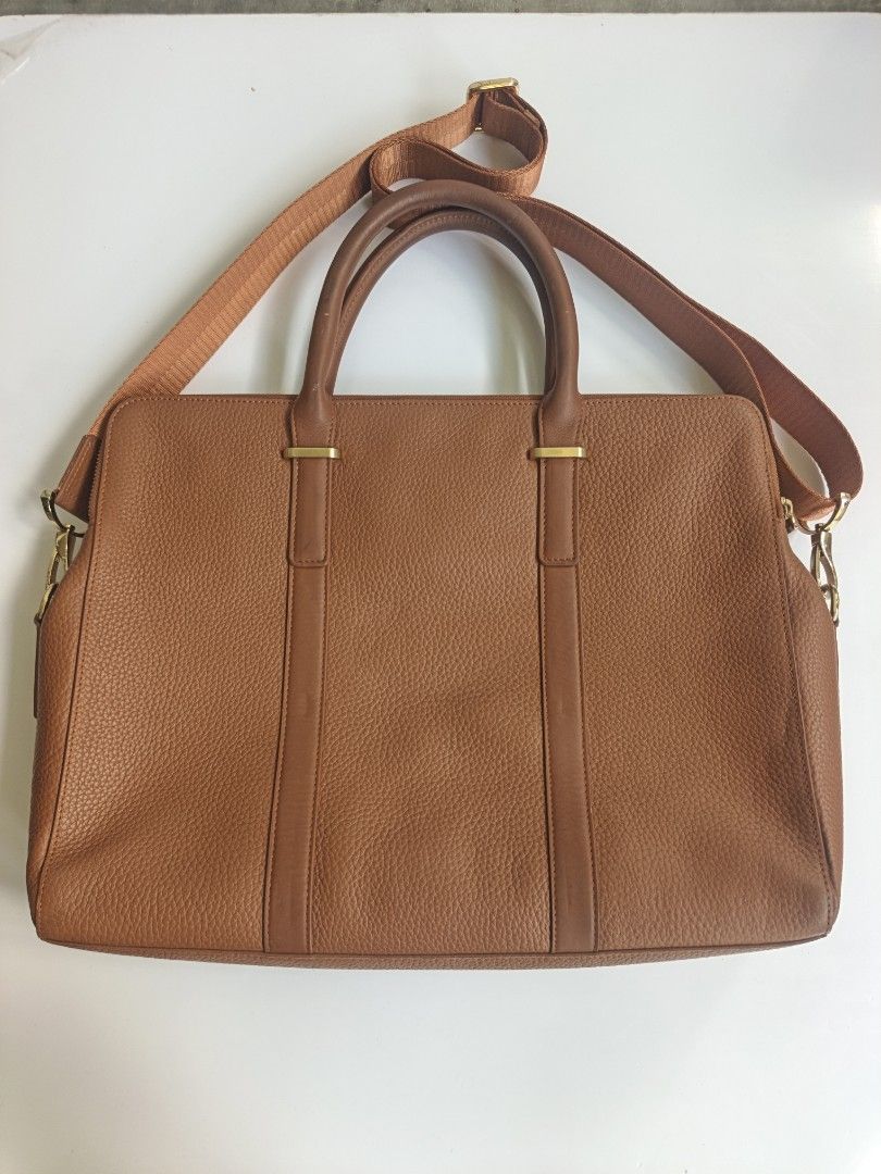 Loewe Postal Brown Leather Handbag with Shoulder Strap (Category: Luxury Bags & Wallets) located in Cavite. Submitted by benta_bounce (Listing ID 1461618710, Image 2). Description: - Stylish brown pebbled leather tote bag - Elegant gold hardware details - Comfortable top handles - Includes a detachable shoulder strap for versatility - Secure zipper closure to keep your belongings safe - Multiple interior compartments for organized storage - Spaci