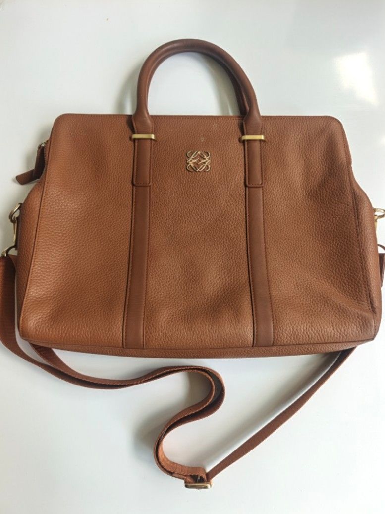 Loewe Postal Brown Leather Handbag with Shoulder Strap (Category: Luxury Bags & Wallets) located in Cavite. Submitted by benta_bounce (Listing ID 1461618710, Image 1). Description: - Stylish brown pebbled leather tote bag - Elegant gold hardware details - Comfortable top handles - Includes a detachable shoulder strap for versatility - Secure zipper closure to keep your belongings safe - Multiple interior compartments for organized storage - Spaci