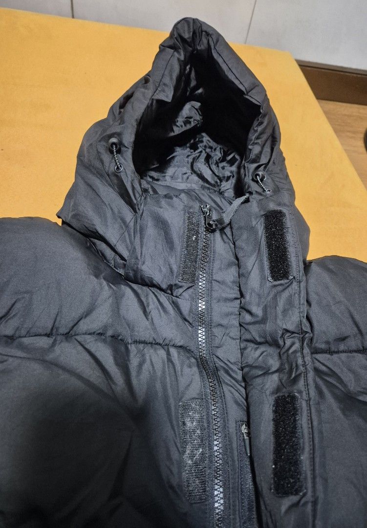 Long Black Puffer Coat with Hood (Category: Coats, Jackets and Outerwear) located in Manila. Submitted by sorayabarr50152 (Listing ID 1460857036, Image 3). Description: - Long black puffer coat - Features a hood - Quilted design - Knee-length - Button closure at the front - Side pockets - Ideal for cold weather - Simple and functional.