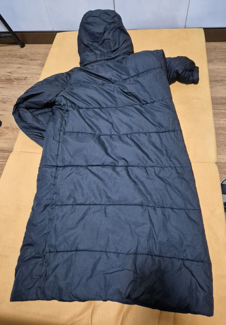 Long Black Puffer Coat with Hood (Category: Coats, Jackets and Outerwear) located in Manila. Submitted by sorayabarr50152 (Listing ID 1460857036, Image 2). Description: - Long black puffer coat - Features a hood - Quilted design - Knee-length - Button closure at the front - Side pockets - Ideal for cold weather - Simple and functional.