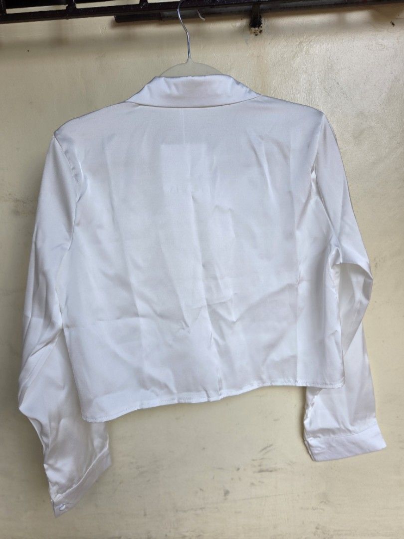 Long-sleeved, white satin button-down (Category: Blouses) located in Agdangan. Submitted by wearitnext.shop (Listing ID 1461563178, Image 3). Description: Long-sleeved satin button-down shirt with a slightly cropped, straight hem. Original Price: 420.