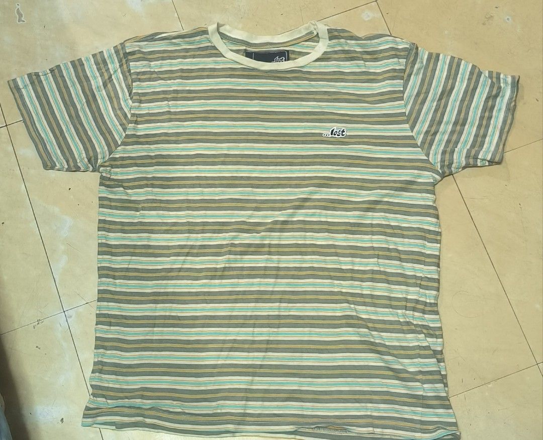 LOST Striped T-Shirt Size M (Category: Tshirts & Polo Shirts ) located in Manila. Submitted by itsmelawrence (Listing ID 1461762677, Image 1). Description: - Brand: LOST - Size: M - Color: Horizontal stripes in grey, green, yellow, and white - Features: Small embroidered LOST logo on chest - Material: 100% Cotton - Origin: Made in India.