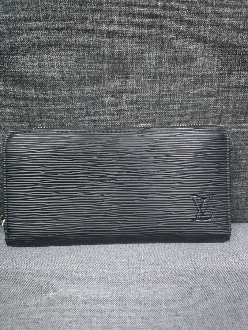 Louis Vuitton Epi Leather Long Wallet (Category: Wallets & Card holders) located in General Trias. Submitted by roselle2230 (Listing ID 1461689750, Image 2). Description: - Authentic Louis Vuitton Long Wallet - Material: Black Epi Leather - Hardware: Silver - Closure: Zip Around - Features: Ample space for cards and cash - Condition: Overall good, with some signs of wear on the zipper pull - Ideal for: Everyday use.