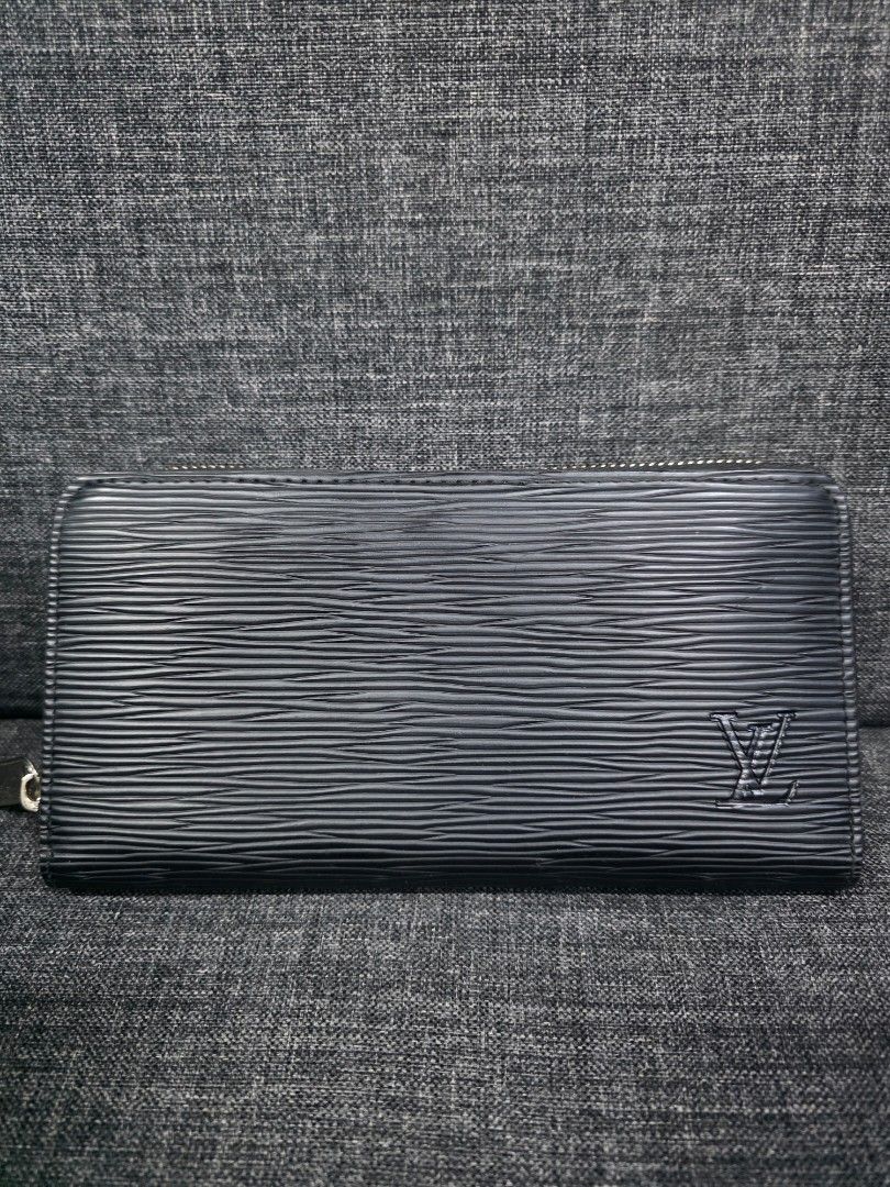 Louis Vuitton Epi Leather Long Wallet (Category: Wallets & Card holders) located in General Trias. Submitted by roselle2230 (Listing ID 1461689750, Image 3). Description: - Authentic Louis Vuitton Long Wallet - Material: Black Epi Leather - Hardware: Silver - Closure: Zip Around - Features: Ample space for cards and cash - Condition: Overall good, with some signs of wear on the zipper pull - Ideal for: Everyday use.