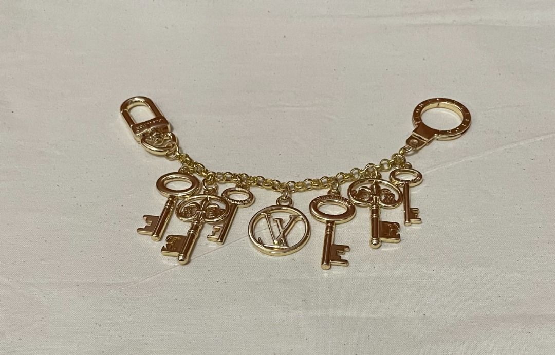 Louis Vuitton Keys Bag Charm (Category: Other Accessories) located in Quezon City. Submitted by garagesale2026 (Listing ID 1461796708, Image 1). Description: - Brand new - From Japan - LV Inspired only - Gold tone with multiple key pendants and centered LV logo - Connected by a chain - Perfect for bags.