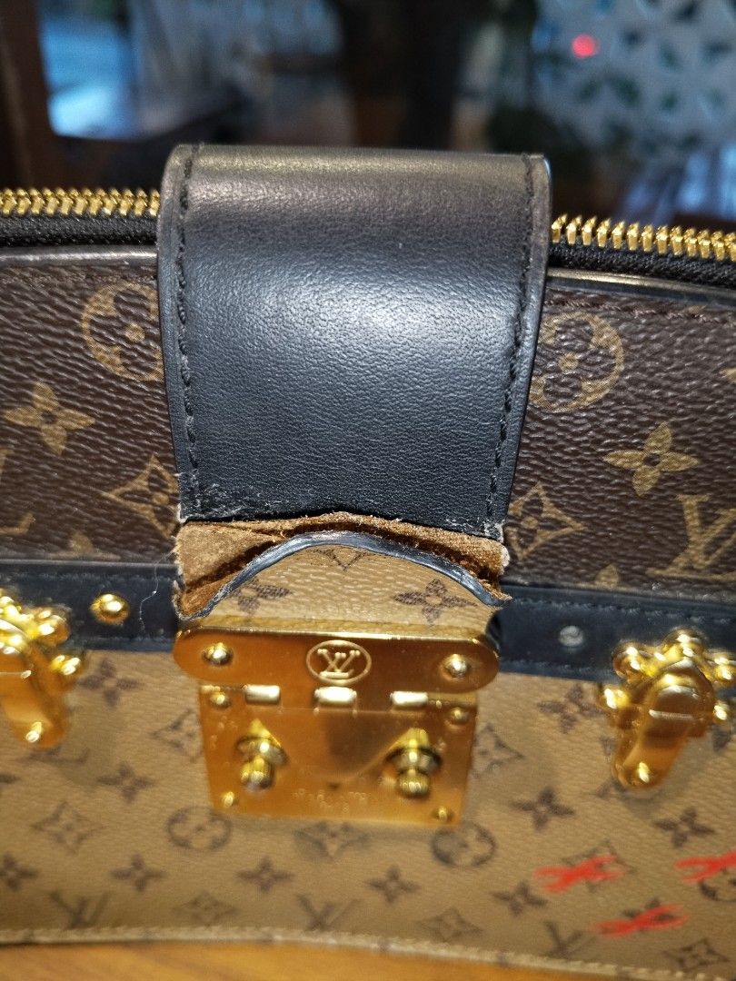 Louis Vuitton Monogram Trunk Clutch Bag (Category: Luxury Bags & Wallets) located in Pasig City. Submitted by loveforlux_2025 (Listing ID 1461589926, Image 3). Description: - Louis Vuitton clutch bag -replaced sling strap - Monogram canvas with black leather trim - Signature LV lock closure - Minor red markings on front canvas - Detachable leather strap - Gold-tone hardware - Some wear on leather strap attachment.